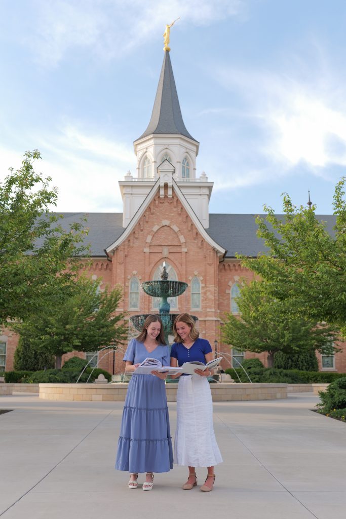 reading mission books in front of LDS temple