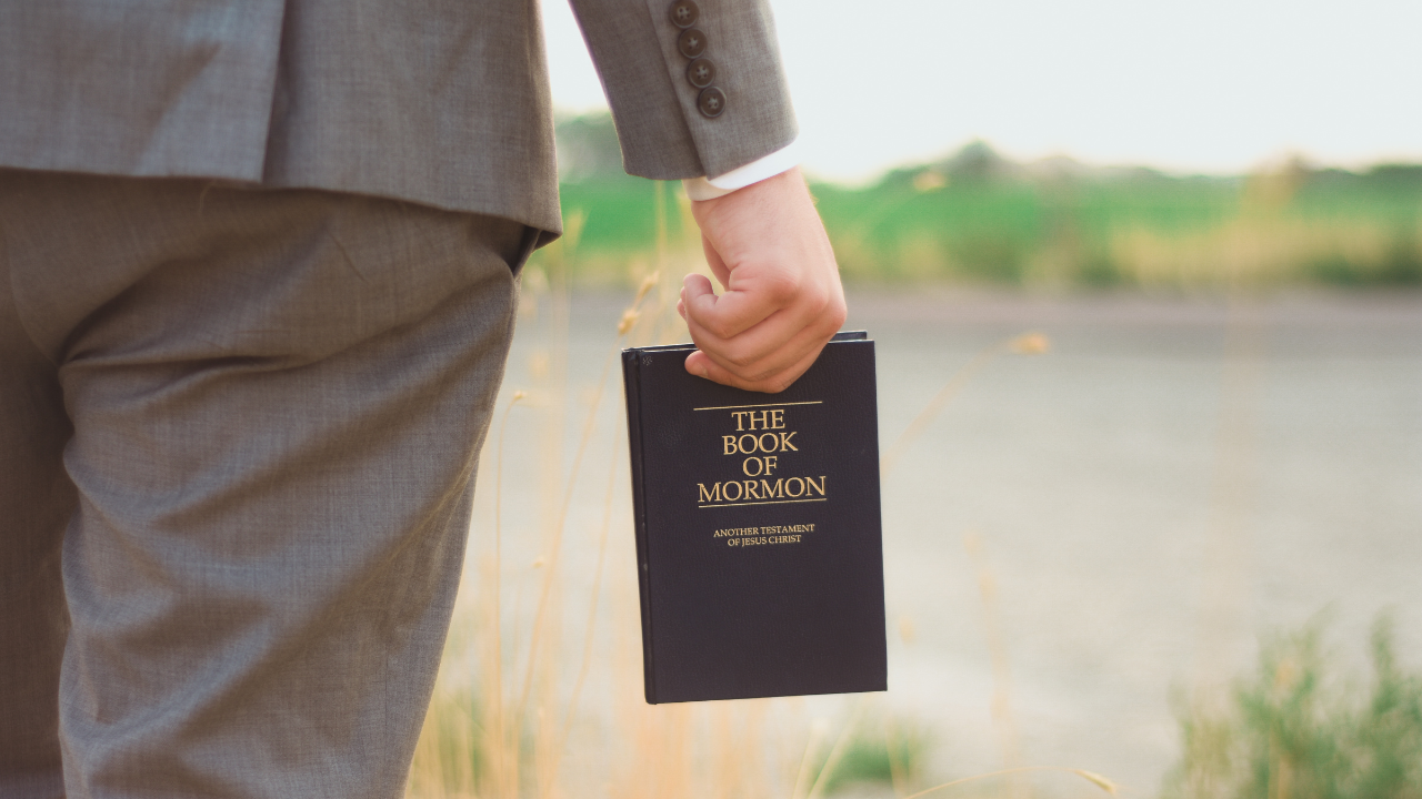 lds missionary holding book of mormon